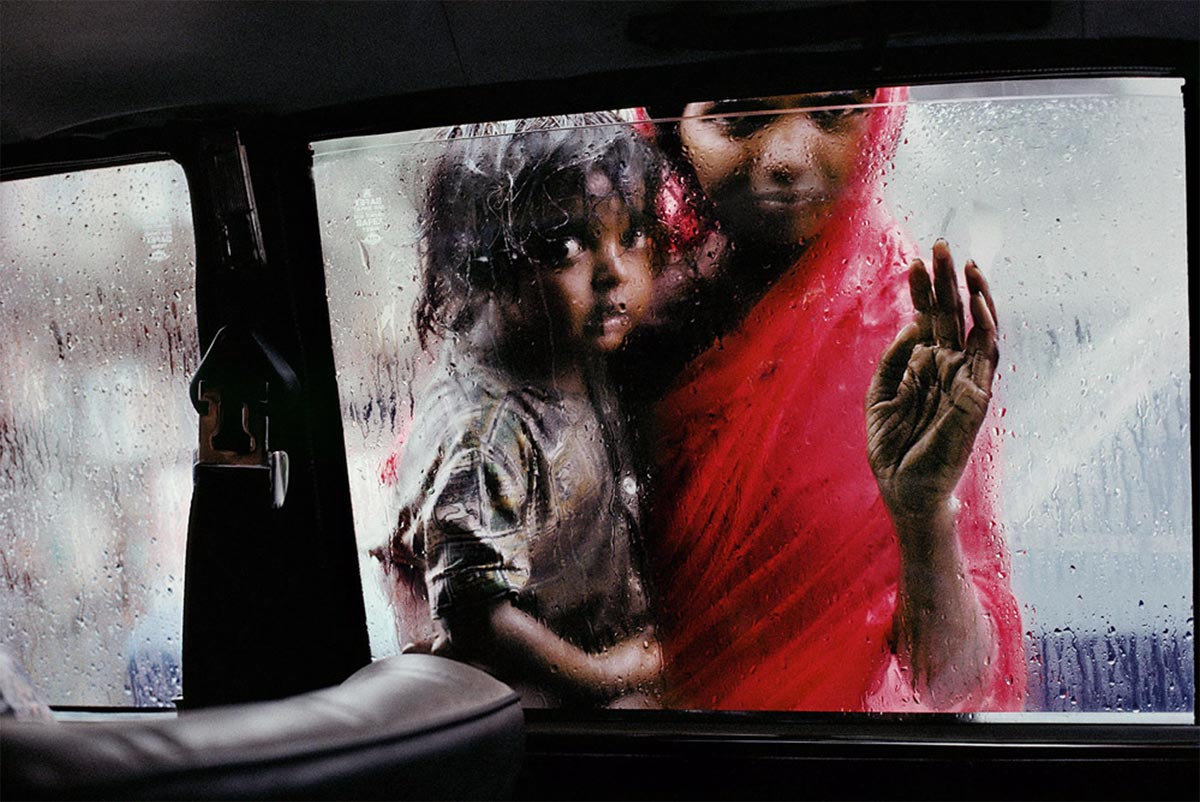 STEVE MCCURRY, Mother and Child at Car Window, 1993